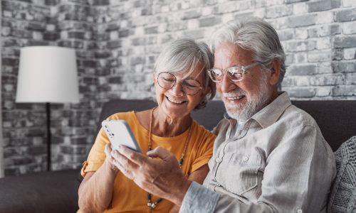 Elderly,Grandfather,And,Grandmother,Spend,Time,Having,Fun,Using,Smartphone