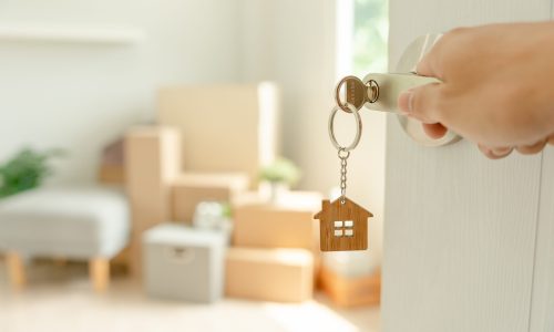Moving,House,,Relocation.,Man,Hold,Key,House,Keychain,In,New